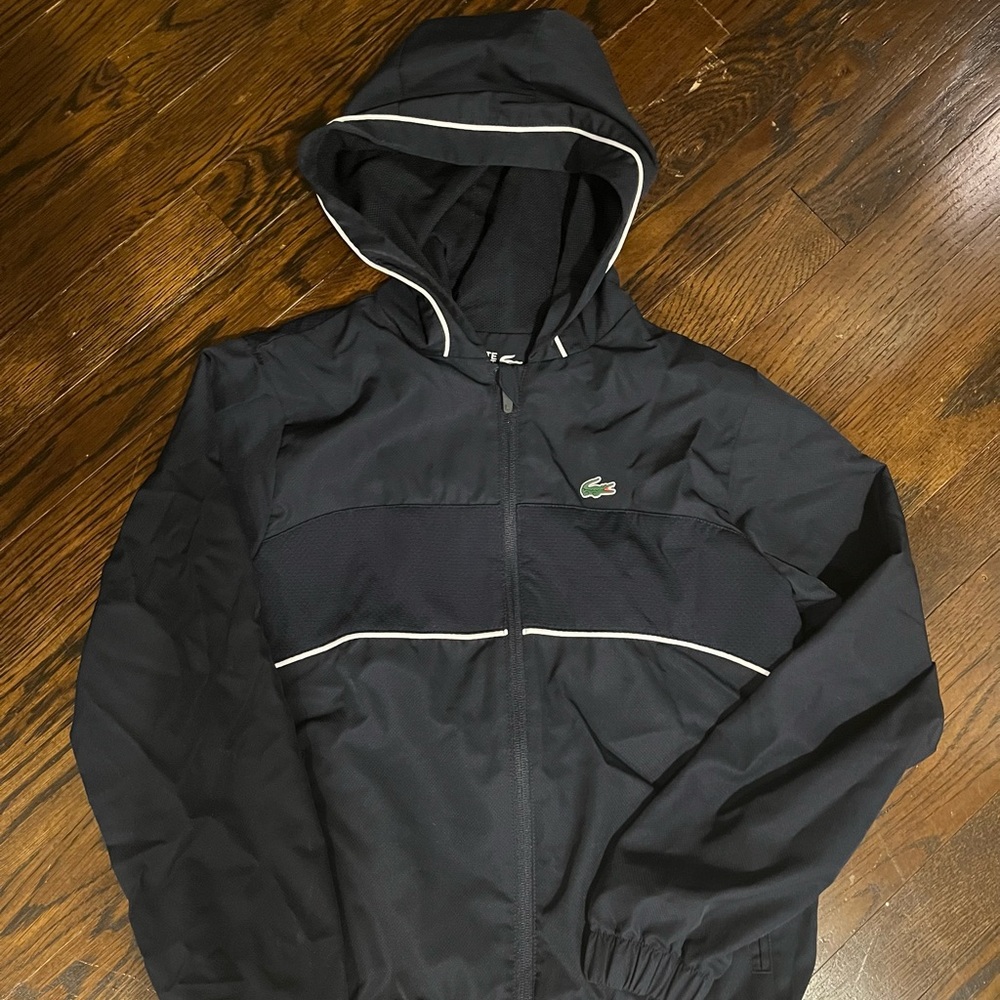 Lightly worn 12 navy Lacoste Sport shell jacket, 100% polyester; zip-up, hood